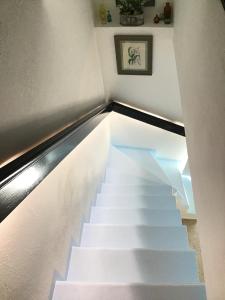 a stairway with white stairs in a room at La Maisonette Antibes in Antibes