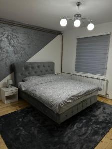 a bedroom with a large bed and a window at Kuća za odmor Pale - Jahorina in Pale +10 photos