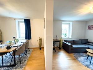 a living room and dining room with a couch and a table at Klassen Apartments! Schnuckeliges Apartment - mit Balkon -in Bad Saulgau -für vier Personen - 1 OG in Bad Saulgau
