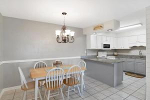 a kitchen with a table and chairs and a dining room at Cotton Bayou Unit 8B in Orange Beach