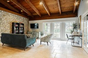 a living room with a couch and a tv at Park Shore Resort, 1st Floor, Bldg. A in Naples