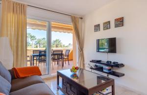 a living room with a couch and a tv and a table at Fantastic Apartment 80m from the Beach! in Marbella