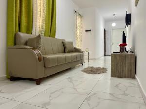 a living room with a couch and a television at 2 Bedroom apartment close to the beach in St Paul's Bay