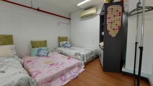 a room with two beds and a snowboard on the wall at CEO SoHo Suite - biz/holiday in Bayan Lepas