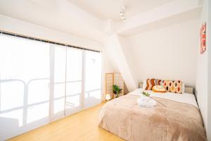 a bedroom with a bed and a large window at Aurora 5 in Tokyo