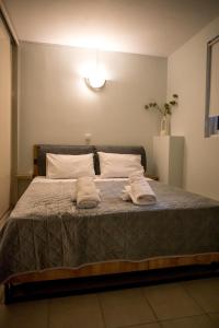 a bedroom with a bed with two towels on it at Leggero in Preveza