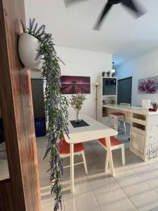 a living room with a table and a desk at Benoni 3 Bedroom - Farah Biz Empire Homestay in Papar