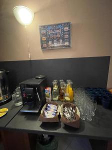 a counter top with a coffee maker and some food at Good Spot Zieleniec Twin Eco 01 in Duszniki Zdrój