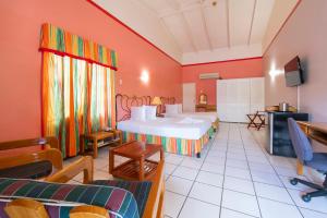 a hotel room with two beds and a tv at The Chancellor Hotel in Port-of-Spain