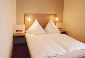 Postel nebo postele na pokoji v ubytování Hotel Mühleneck