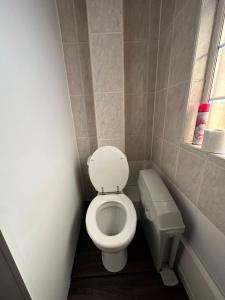 a small bathroom with a toilet and a window at Joshmore in Attercliffe