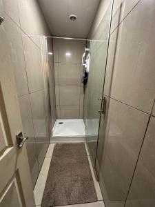 a shower with a glass door in a bathroom at Joshmore in Attercliffe