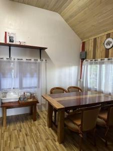 a dining room with a wooden table and chairs at Cabin A at Bigang Munti in Batangas City