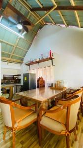 a dining room with a table and chairs at Cabin A at Bigang Munti in Batangas City