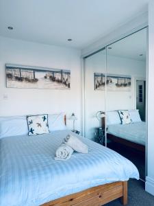 a bedroom with two beds and a view of the beach at Longsands Beach, Apartment 3, Tynemouth in Tynemouth