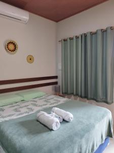 a bedroom with two towels on a bed at Casa Carauarí in Alter do Chao +22 photos