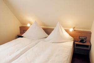 Postel nebo postele na pokoji v ubytování Hotel Mühleneck