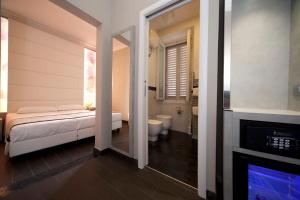 a bathroom with a bed and a toilet and a fireplace at B&B Residenza le Fonticine in Florence