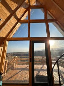 a view from the inside of a cabin with a large window at A Frame Denver in Ashtarak