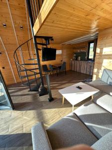 a living room with a staircase and a couch and a table at A Frame Denver in Ashtarak