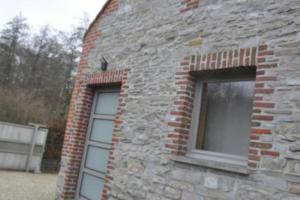 a brick building with two windows on it at Magnifique logement, 2 chambres, in Péruwelz