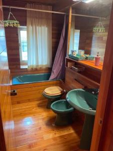 a bathroom with a sink and a toilet and a tub at Casa in centro storico stile chalet di montagna in Ovindoli
