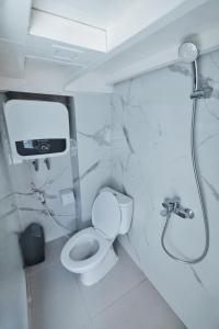 a bathroom with a toilet and a shower at Phinisi sailing Komodo 3 days 2 night in Labuan Bajo