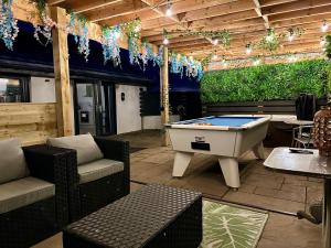 a patio with a pool table on a patio at Bothy Farm Stay Sleeps 2 HotTub and Pool Table Children Welcome Ayrshire Rural Retreats in Newmilns