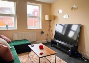 a living room with a large flat screen tv at Charming Flat in Central Bristol in Bristol