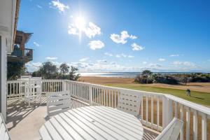 a white deck with a table and chairs on the beach at MS15 Sound View in Nags Head