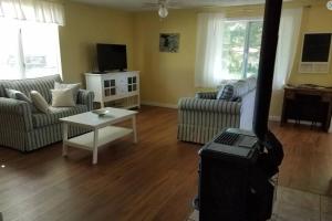 a living room with a couch and a table at Pet Friendly Cottage in Thompsonville
