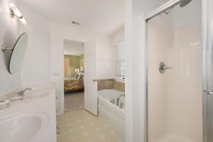 a bathroom with a tub and a sink and a shower at MS15 Sound View in Nags Head +53 photos