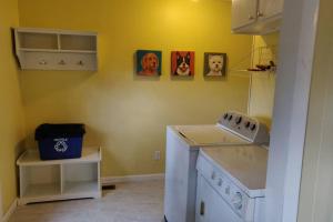 a kitchen with a sink and a stove top oven at Pet Friendly Cottage in Thompsonville