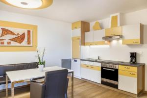 a kitchen with a table and a dining room at Apart Rofan 45m2 in Bruck am Ziller