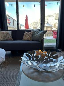 a living room with a couch and a table at appartement Terrasse 1 chambre ORDINO HUT3-008298 in Ordino
