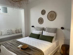 a bedroom with a bed with a hat on it at Konstantza's Elegant Apartment in Naxos Chora