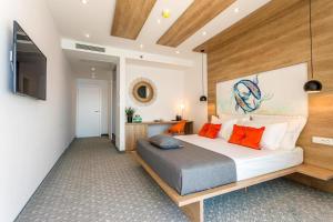 a bedroom with a large bed and a television at Hotel Saint Hildegard in Omiš