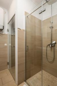 a shower with a glass door in a bathroom at Apartments Neo in Rijeka