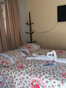 Un pat sau paturi într-o cameră la POUSADA MARIA FLOR