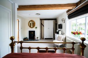 a bedroom with a bed and a living room at The Red Lion in East Bergholt