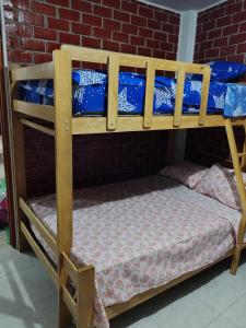 two bunk beds in a room with a brick wall at Disfruta de paz y armonía en huaral in Huaral