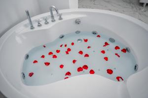 a white bath tub with red hearts on it at Delago in Ohrid