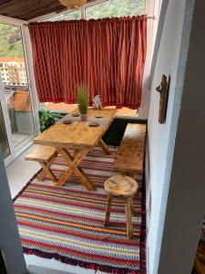 a table and two stools on a porch with a window at Lovely newly refurbished, 1 bedroom top floor apartment with sea views, fast WI-FI CABLE TV and Netflix in Ribeira Brava