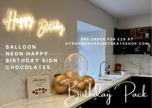 a group of balloons on a counter with a happy birthday sign at Hazells Lodge Farm Stay Sleeps 2 Hottub Pool Table at Ayrshire Rural Retreats in Galston