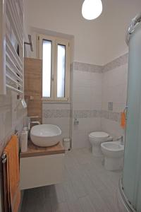 a bathroom with a sink and a toilet at Moro Central Apartment by Wonderful Italy in Cefalù