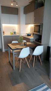 a kitchen with a table and chairs in a kitchen at departamento concon in Concón