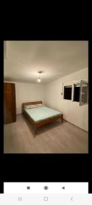 a room with a bed in the corner of a room at Vlado apartments in Podgorica