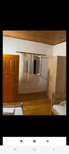 a small room with two beds and a door at Vlado apartments in Podgorica