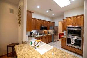 a kitchen with wooden cabinets and a sink in it at *20% New Listing Discount! Tramway Home By Sandias in Albuquerque