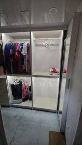 a walk in closet with white doors and clothes at Harvey's Oasis - Cruise Port, Us Embassy, Oval and Vacation in Bridgetown